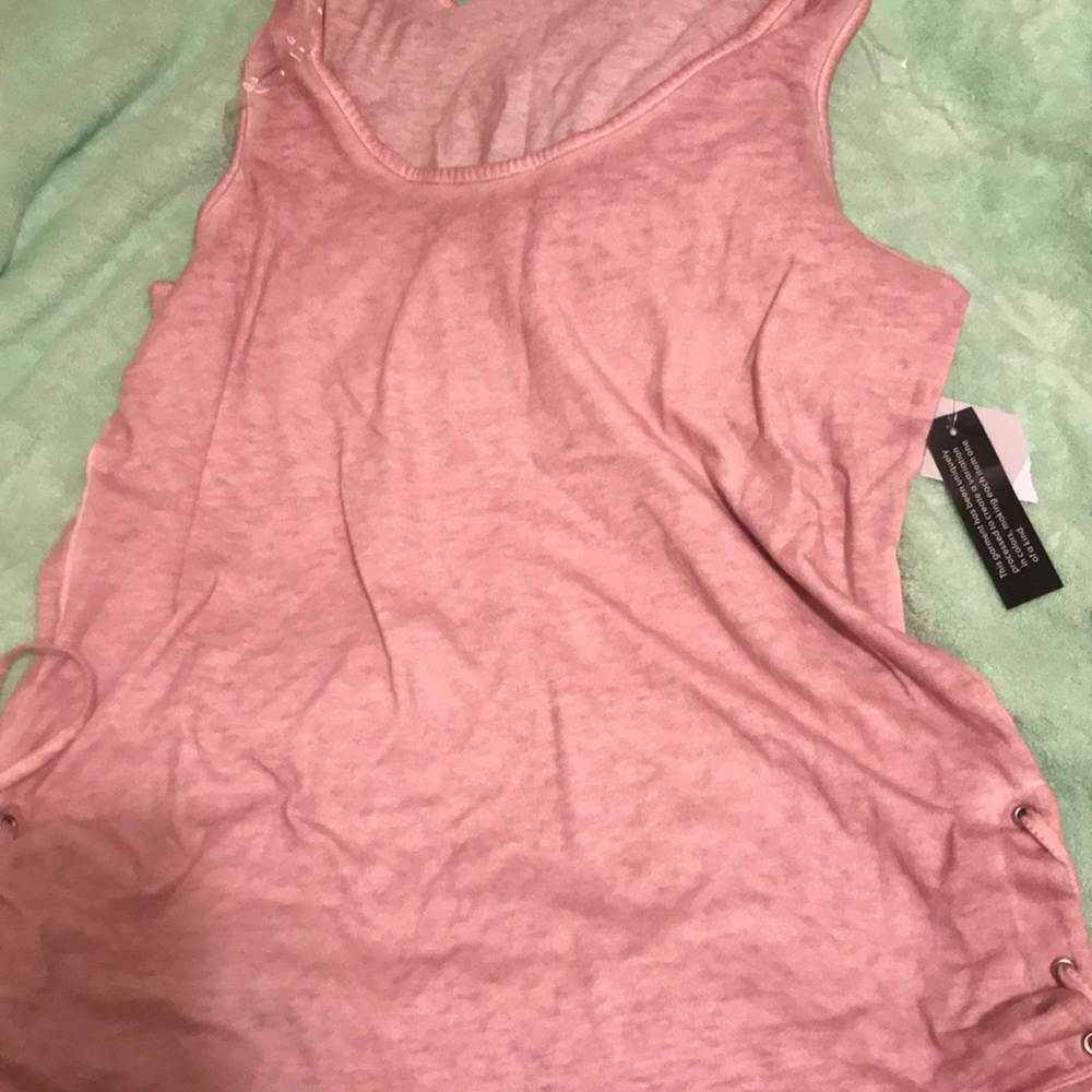 A sleeveless lace up tank mauve